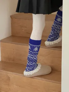 Cozy knitted Fair Isle leg warmers for women, winter thick warm stirrup socks detail.