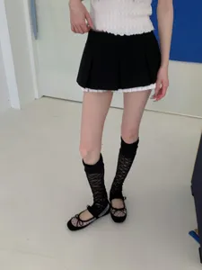 Detail shot of Japanese sweet cool lace ruffle socks paired with pleated skirt and shoes.