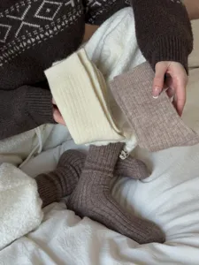 Close-up detail of cozy knit wool socks featuring soft ribbed texture and warm winter tones.