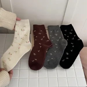 Detailed view of cozy retro floral mid-calf socks in various colors for autumn and winter.