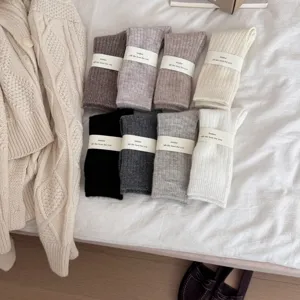 Cozy solid color wool knit mid-tube socks, warm thick winter hosiery with elegant paper band packaging.