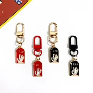 Halloween metal tombstone keychain with skeleton hand design, stylish couple bag phone pendant.