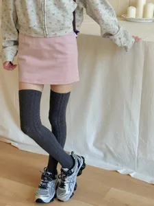 Knit over-the-knee socks detail view, cable knit texture, cozy sweet style outfit styling shot.