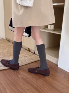 Korean style solid color calf socks with letter label detail, soft cotton crew socks.