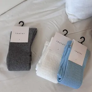 Detailed view of IOULOR ribbed long socks in grey white blue, cozy cotton knitwear.