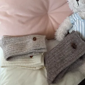 Cozy wool knit socks with cute button detail, thick warm winter crew socks for women.
