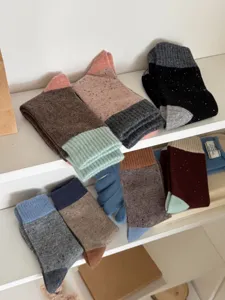 Detailed view of cozy merino wool color-block winter socks featuring soft speckled knit texture.