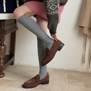 Solid color grey knee-high socks for women, retro casual fashion style, comfortable daily wear.