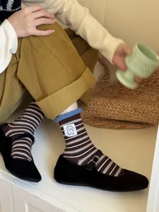 Cozy brown white striped mid tube socks with cute puppy embroidery patch and black Mary Jane shoes.