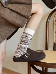 Close-up detail of cozy knit Fair Isle slouch socks for women, thick warm winter leg warmers.