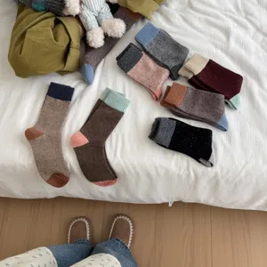 Thickened Merino wool colorblock mid-tube socks, warm and cozy winter thermal hosiery.
