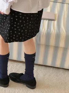 Korean style cotton mid-calf socks with delicate letter embroidery for daily wear outfit.