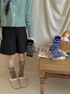 Detailed view of Fair Isle knit slouch socks and leg warmers with vintage patterned design.