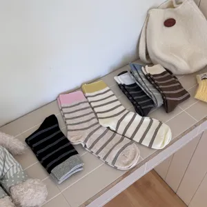 Detailed view of Japanese striped mid-calf socks showcasing soft combed cotton material and cozy design.