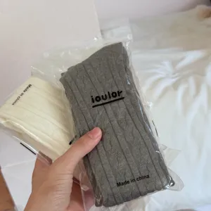 Cable knit over knee socks detail, soft warm long stockings for women, cozy winter wear.