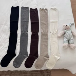 Cozy over-the-knee wool long stockings in versatile solid colors, warm and stylish autumn winter wear.