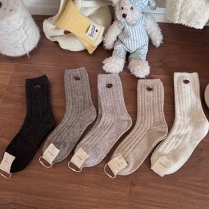 Cozy wool winter socks for women, thick warm knit crew socks with cute button design.