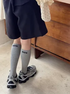Korean style solid color cotton calf socks with letter patch for spring and autumn daily wear.