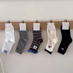 Cute cartoon embroidery mid-tube socks detail, casual style, soft and comfortable fabric.