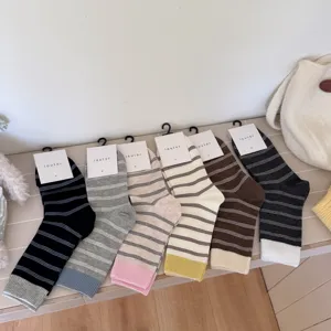 IOULOR Japanese striped color-block mid-calf socks for women, comfortable combed cotton.