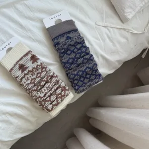 Detailed view of Fair Isle knit leg warmers in cozy brown and grey winter styles.