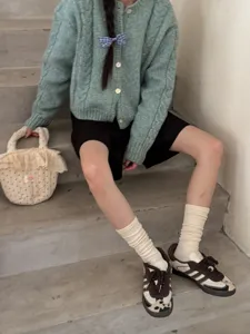 Ribbed knit scrunchie socks detail view, soft cotton long socks for daily cozy outfit styling.