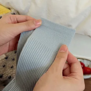 Solid light blue ribbed mid tube socks detail close up showing soft fabric texture and elastic cuff