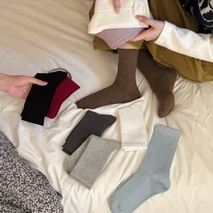 Solid color ribbed long socks for women, cozy winter casual knit mid-tube hosiery daily wear.