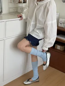 Light blue solid color stirrup leg warmers, Korean style cute stacked socks for women detail.