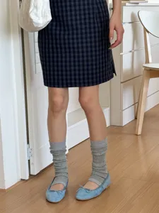 Grey knit stirrup socks detail shot, Korean style stacked leg warmers for women daily outfit.