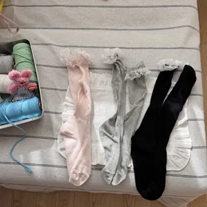 Detail view of lace ruffle slouch socks, pink, grey and black thin summer breathable style.