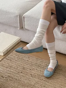 Detail view of Korean style solid color slouchy leg warmers paired with cute blue ballet flats.