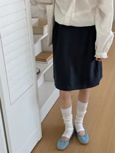 Korean style solid color foot stirrup socks detail view, versatile white leg warmers for women.