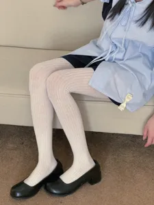 Detailed view of women's white ribbed pantyhose, comfortable daily wear style and design.