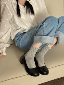 Sweet Japanese style mid-tube socks with cute ruffed edges and classic grey stripes for daily wear.