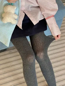 Close-up detail shot of women's grey ribbed tights, showing high stretch and soft comfort.