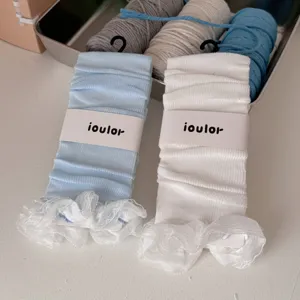 Detailed shot of sweet Japanese style ruffle leg warmers, cute knit hosiery accessories.