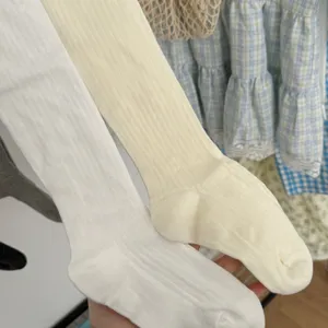 Detailed shot of soft cotton vertical striped tights in white and cream, elastic and comfortable.
