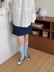 Close-up detail of the korean style light blue stirrup leg socks, soft and stylish.