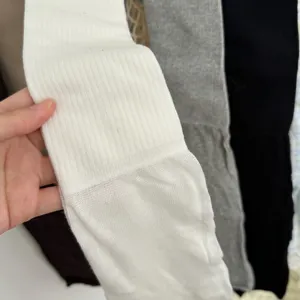 Close-up detail of soft ribbed over-the-knee socks showing fine texture and knit quality.
