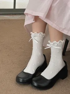 Close-up detail of sweet white ruffle bow dot mid-calf socks for women lovely sweet style.