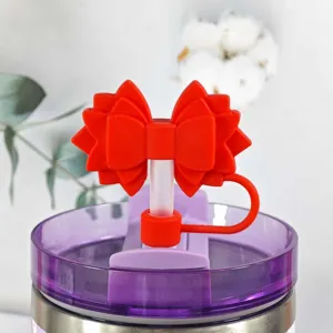 Silicone bow straw cap detail shot, cute red dust plug accessory for tumblers cup.