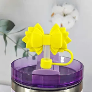 Silicone straw cover with yellow bow design, cute dust plug accessory for Stanley cups.