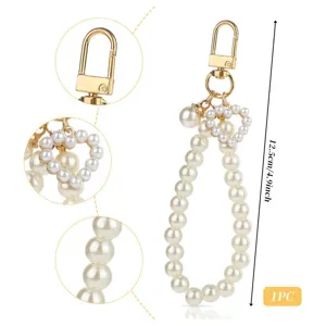 Pearl keychain wrist strap with heart pendant and gold clasp, elegant phone or bag charm.