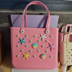 Pink EVA beach tote bag with cute pearl and starfish charms, perfect for summer vacation.