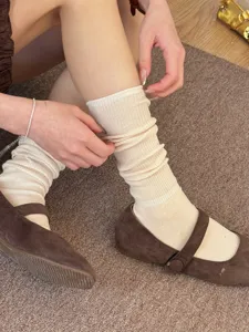 Detailed view of women beige slouch socks, soft breathable cotton long hosiery for daily wear.