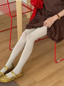 Detailed view of women's white ribbed tights, elastic cotton blend, soft and stylish.