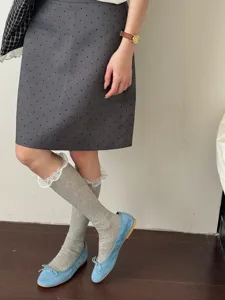 Detailed shot of sweet Japanese style mid-calf socks with delicate white lace trim worn.