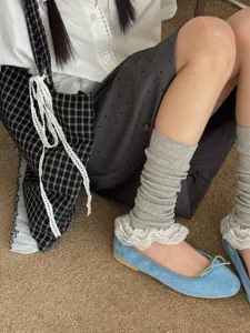 Japanese style lace ruffle leg warmers paired with sweet blue flat shoes, chic detail view.