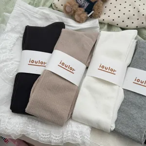 Detailed shot of IOULOR solid color ribbed over-the-knee slouch socks in multi-colors.